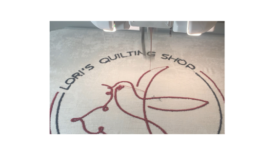 Quilting thread passing through a sewing machine during stitching.